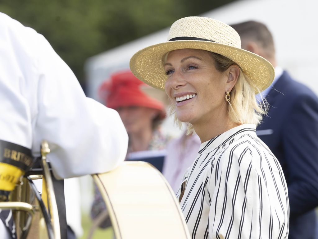 Zara Tindall side on in straw hat and striped dress