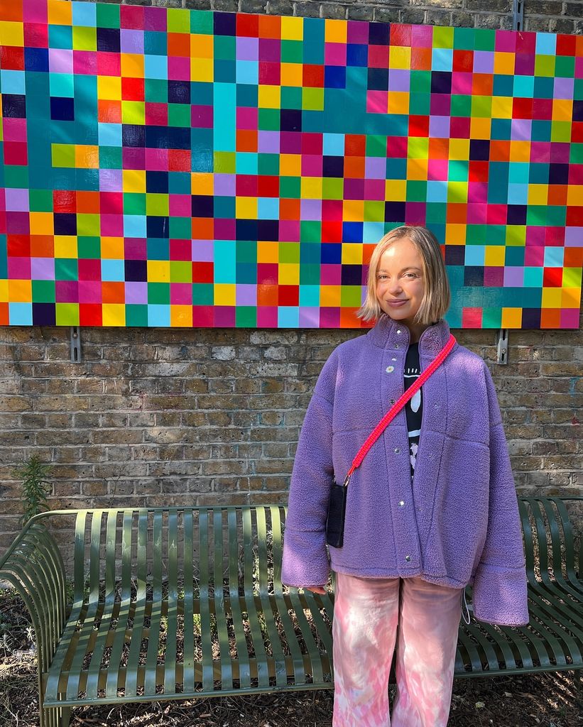 Amelia Windsor wearing a lavendar fleece and psychedelic pink jeans 