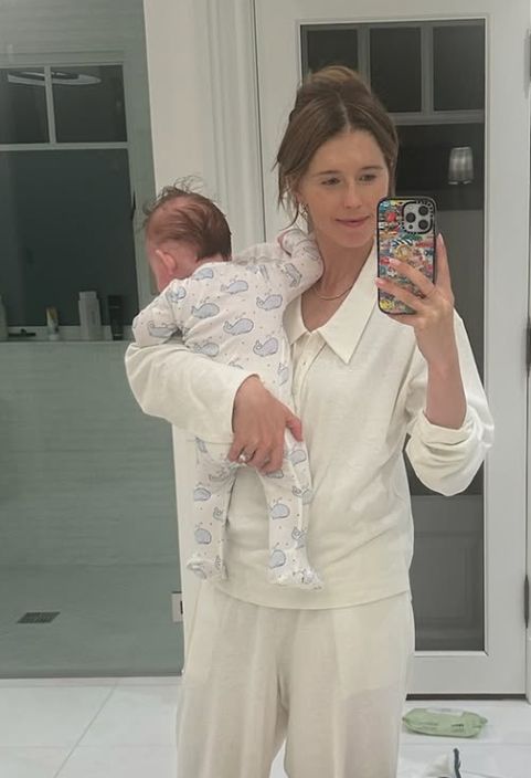Katherine Schwarzenegger holding a baby inside a bathroom