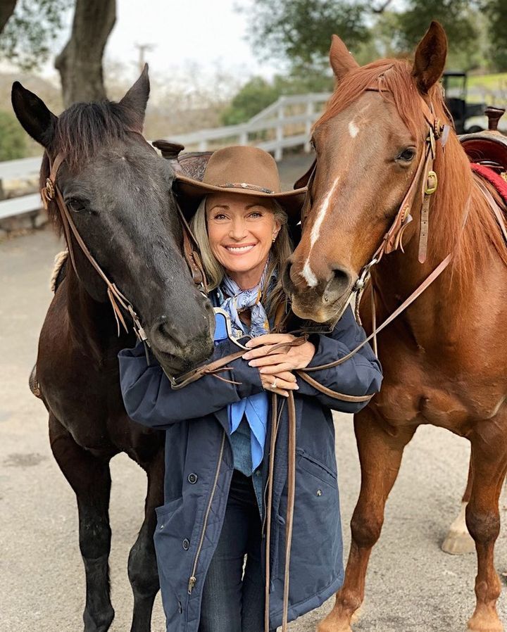 Jane Seymour posing with her pet horses