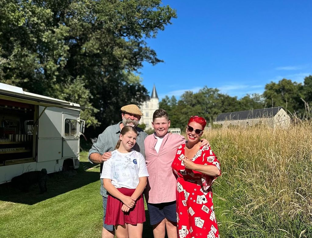 family-of-four posing on lawn