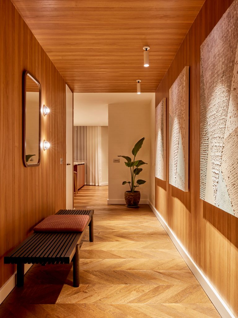 Hallway with wooden bench and plant