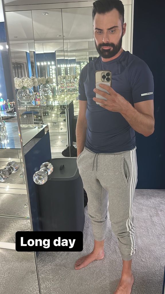 Rylan Clark taking a mirror selfie in casual clothes