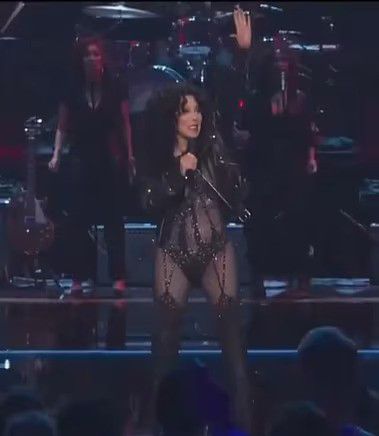 cher on stage in see-through bodysuit