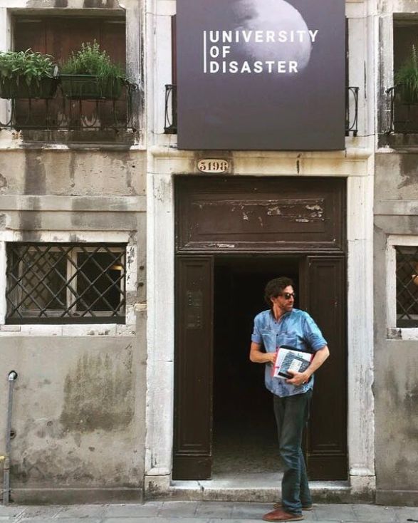 Diego Borella carrying books in front of a building
