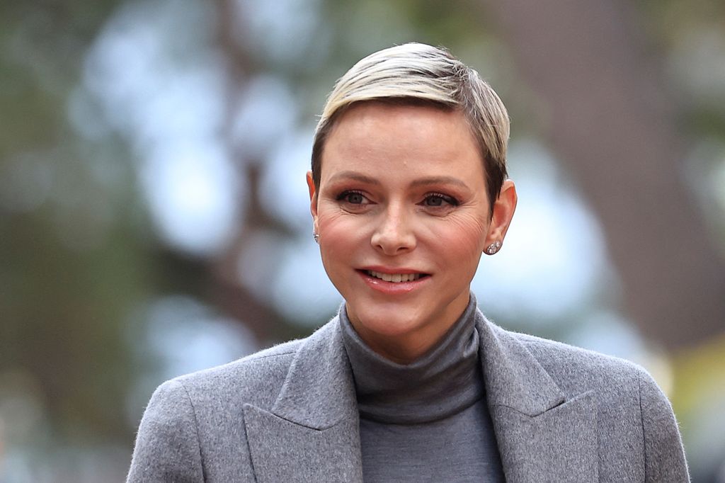 Princess Charlene shoulders up in grey coat