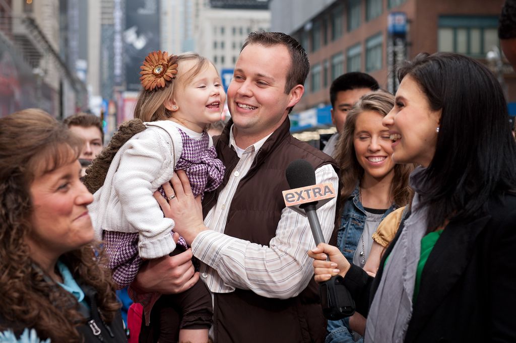 Hilaria Baldwin (R) interviews Josh Duggar and his daughter during their visit with "Extra" in Times Square on March 11, 2013 in New York City