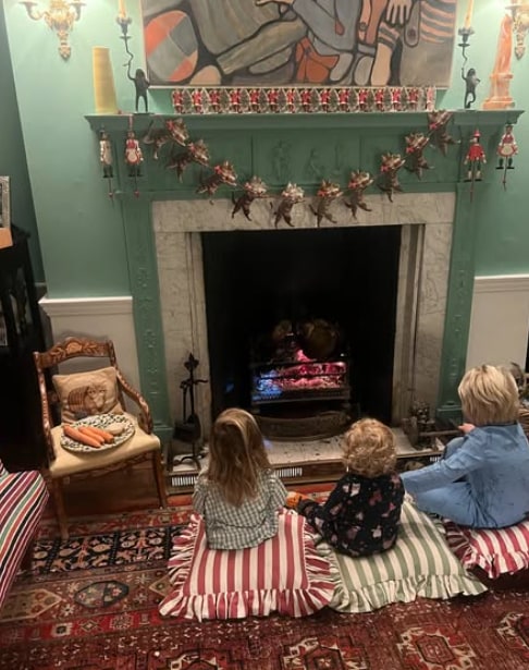 fireplace with three children sat in front