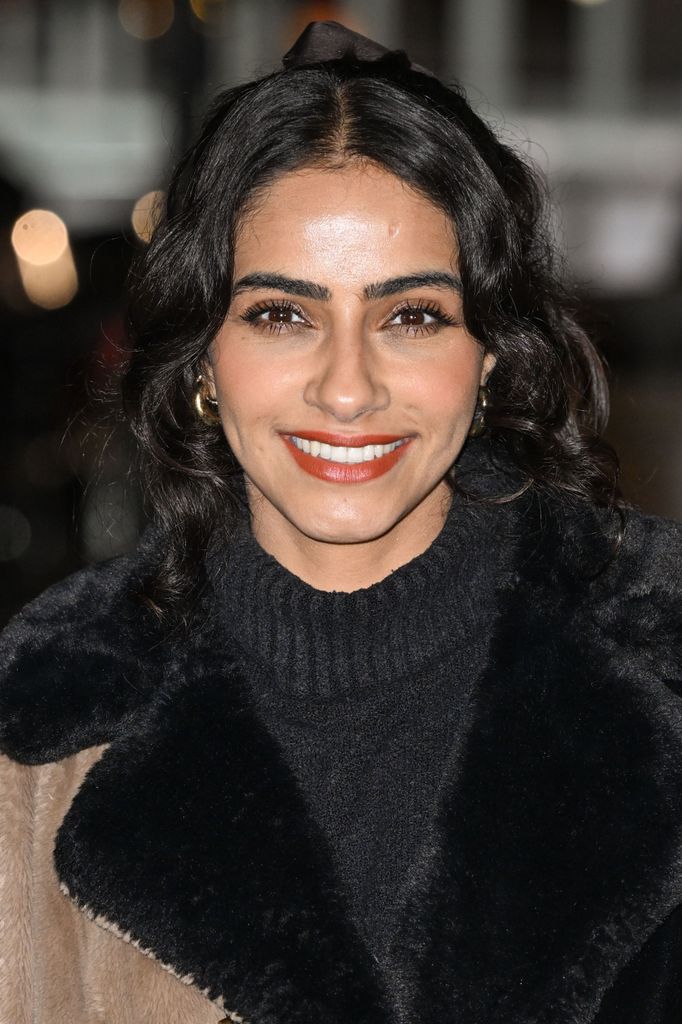 close-up of woman with dark hair smiling
