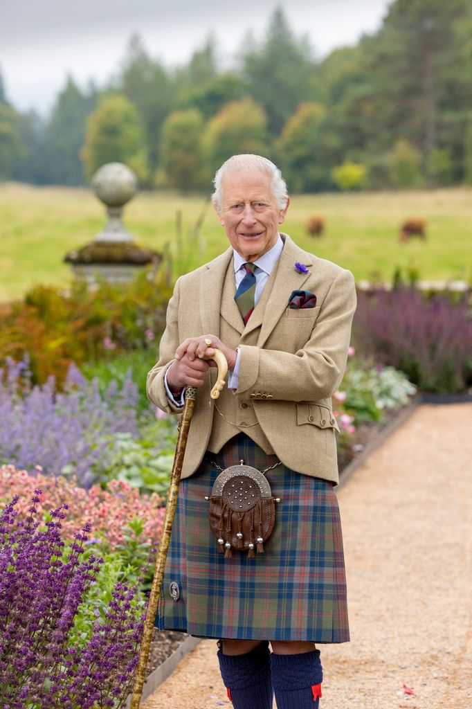 King Charles pictured wearing kilt and holding walking stick at Balmoral Castle