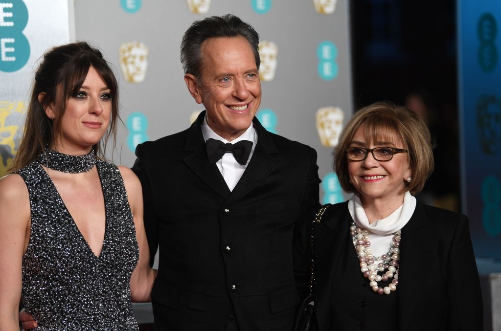 Richard E. Grant (C) and wife Joan Washington (R) attend the 72nd annual British Academy Film Awards at the Royal Albert Hall in London, Britain, 10 February 2019