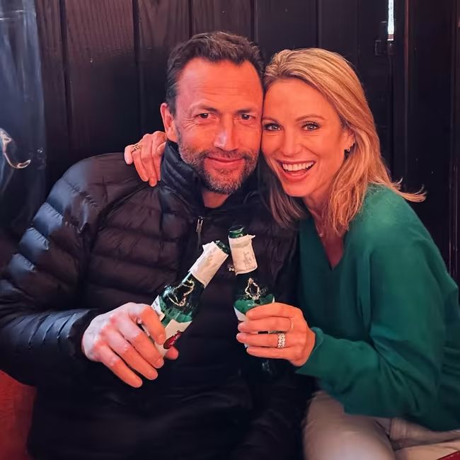 Amy Robach and Andrew Shue cuddling
