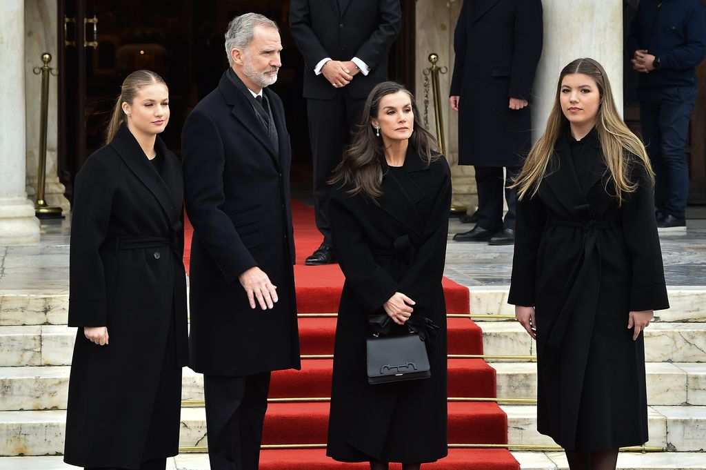 Princess Leonor, King Felipe, Queen Letizia and Infanta Sofia of Spain outside cathedral in black