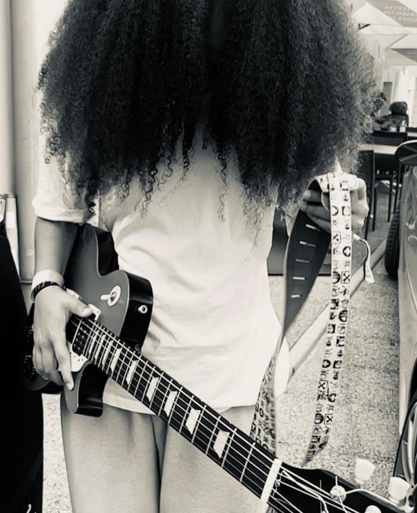 Photo posted by Jamie Foxx on Instagram October 9 2023 of his daughter Anelise, 15, looking down while holding a guitar, as part of a birthday tribute to her.