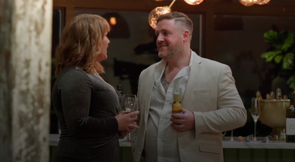 Man and woman holding drinks at party