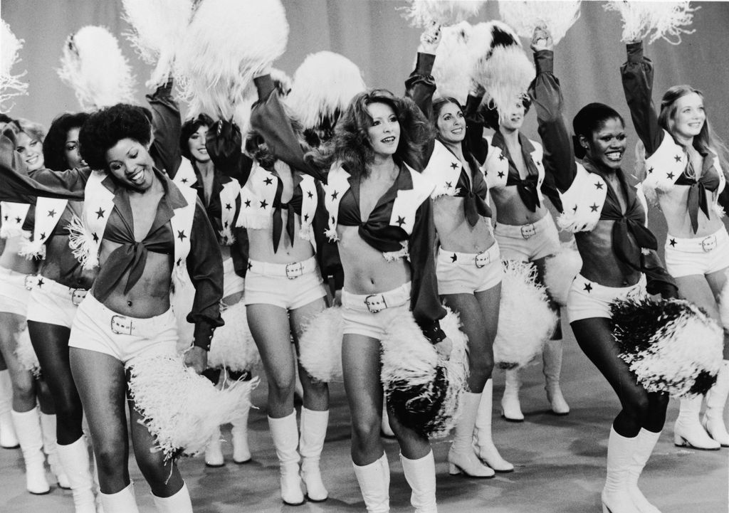 The Dallas Cowboy Cheerleaders perform on stage during the 1970s