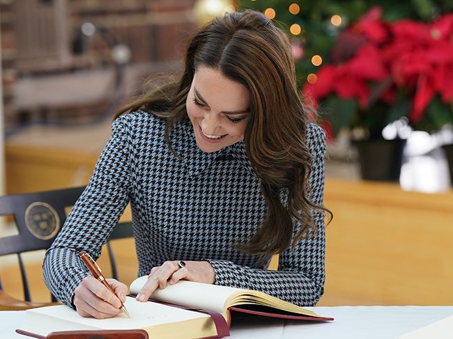 Kate Middleton signs a guest book