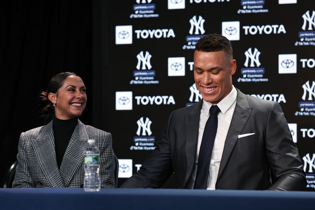 Aaron Judge #99 of the New York Yankees and his wife Samantha Judge look on during a press conference 