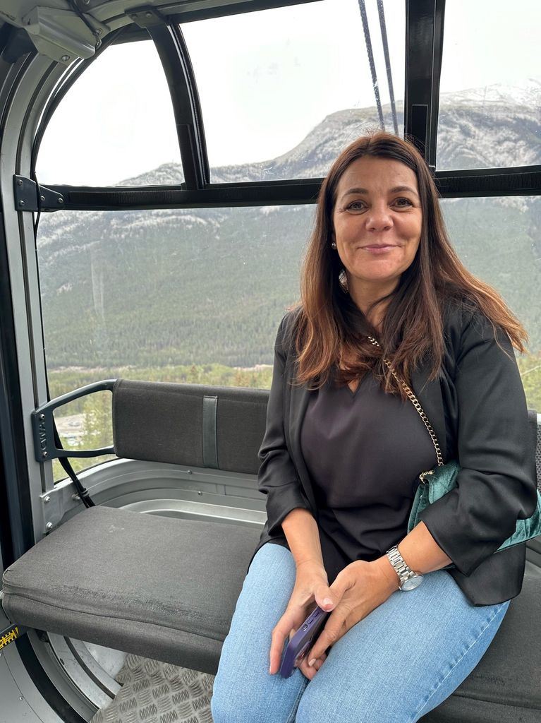 Woman wearing jeans sitting in a cable car