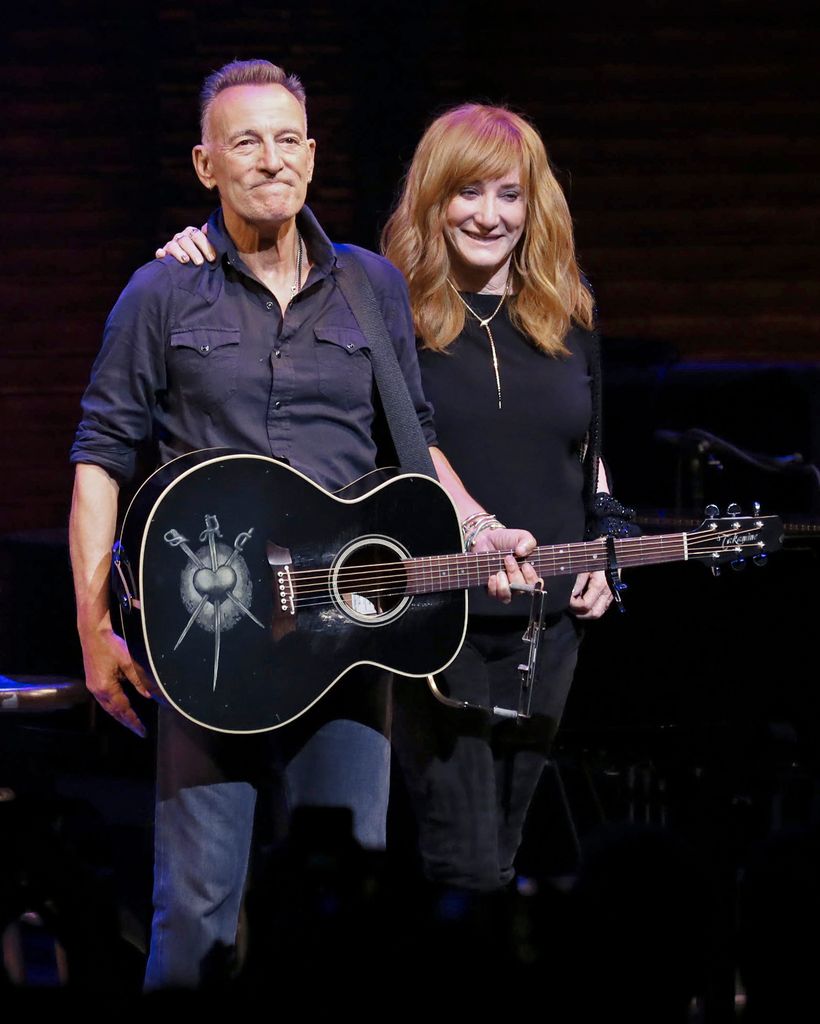 Bruce Springsteen standing with Patti Scialfa