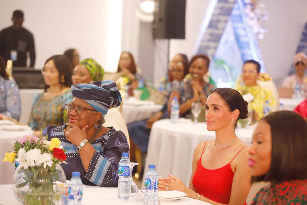 Meghan Markle wearing a red dress at a Women in Leadership event in Abuja, Nigeria. 
