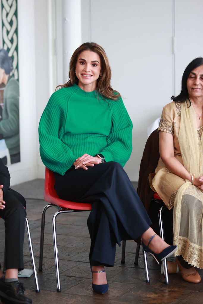 Queen Rania sat down in green jumper