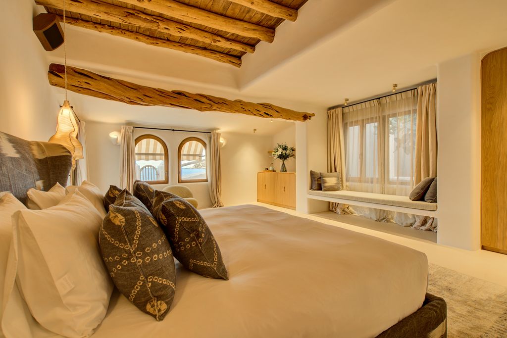 Fincadelica Xarraca bedroom with wooden beams in Ibiza 