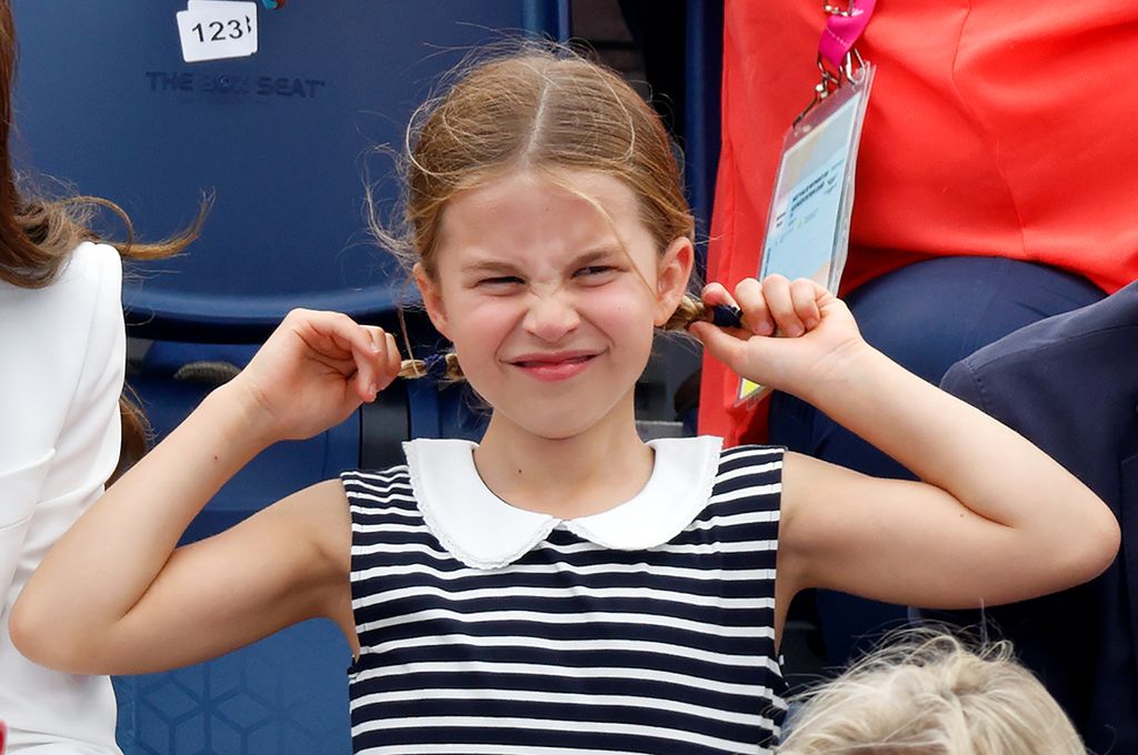Princess Charlotte holding hair out pulling face