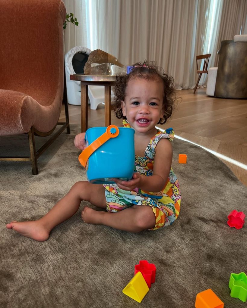 Chrissy teigen's daughter playing with building blocks