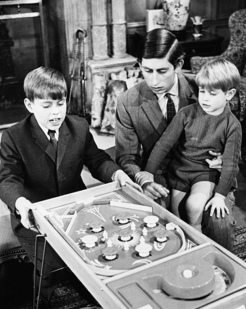 A young Prince Andrew, King Charles and Prince Edward playing Bagatelle