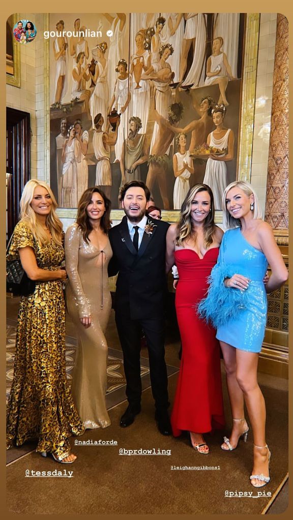 Tess Daly in a leopard print dress with other wedding guests