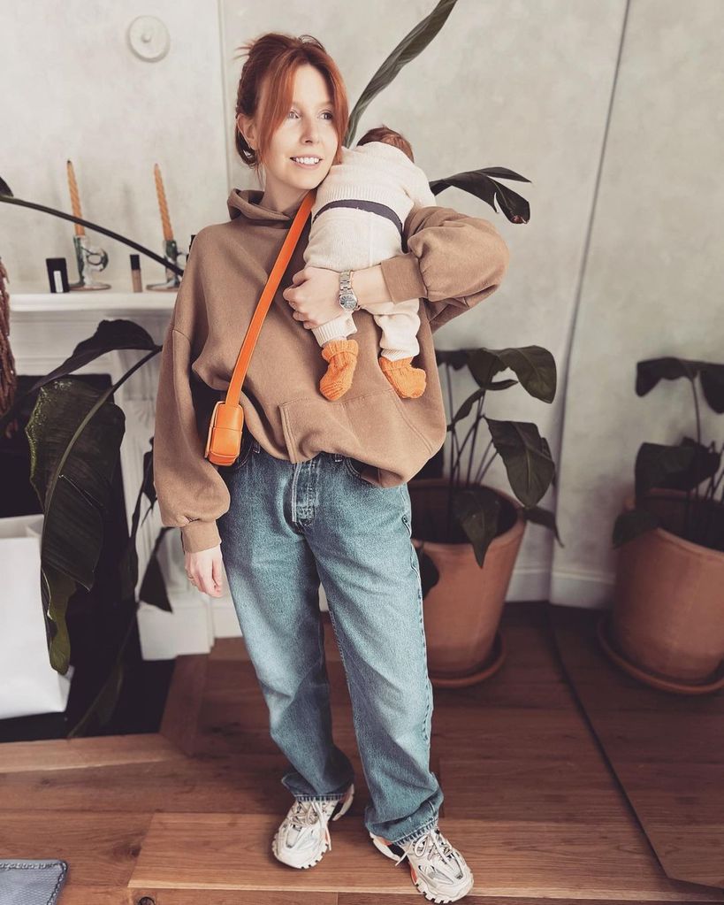 Stacey Dooley holding baby Minnie at home 