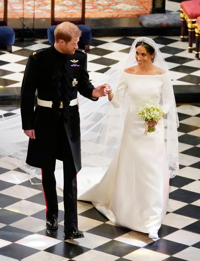 Książę Harry, książę Sussex i księżna Sussex wyjeżdżają po ślubie w kaplicy św. Jerzego na zamku Windsor 19 maja 2018 r. w Windsorze w Anglii. (Zdjęcie: Owen Humphries – WPA Pool/Getty Images)