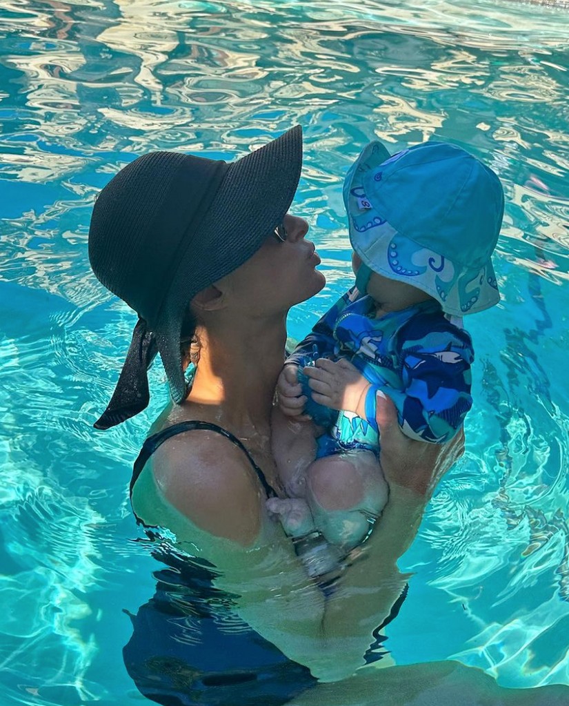 Photo shared by Paris Hilton on Instagram September 2023 of her Labor Day Weekend, where she is in the pool carrying her son Phoenix.