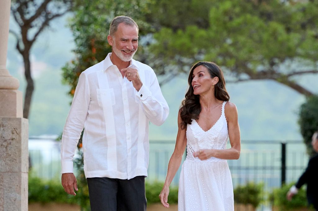 King Felipe and Queen Letizia wearing white and laughing