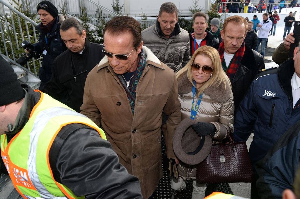 Former US governor and Hollywood actor Arnold Schwarzenegger and his girlfriend Heather Milligan leave the annual Austrian downhill ski race Hahnenkamm race in Kitzbuehel, Austria, 25 January 2014.
