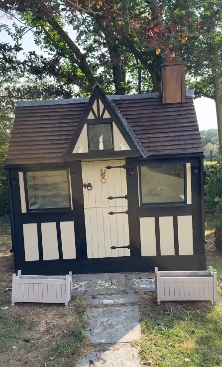 rabbit hutch shaped like house with roof