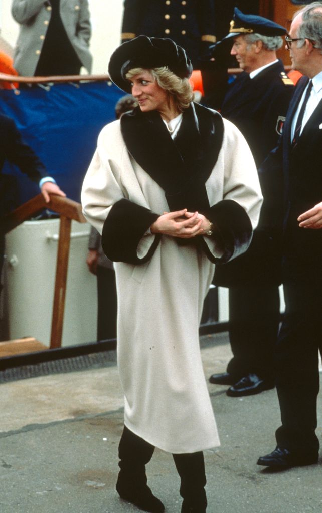 Diana, Princess of Wales, wearing a cream coat with a dark brown fake fur collar and cuffs designed by Arabella Pollen, a matching beret and long black slouchy boots, arrives in Hamburg on November 6, 1987 in Bonn, Germany