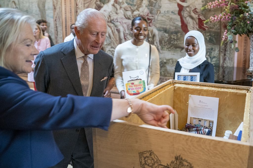 : King Charles III takes a look inside a time capsule during an event at Dumfries House at Dumfries House on October 2, 2025 in Cumnock, Scotland