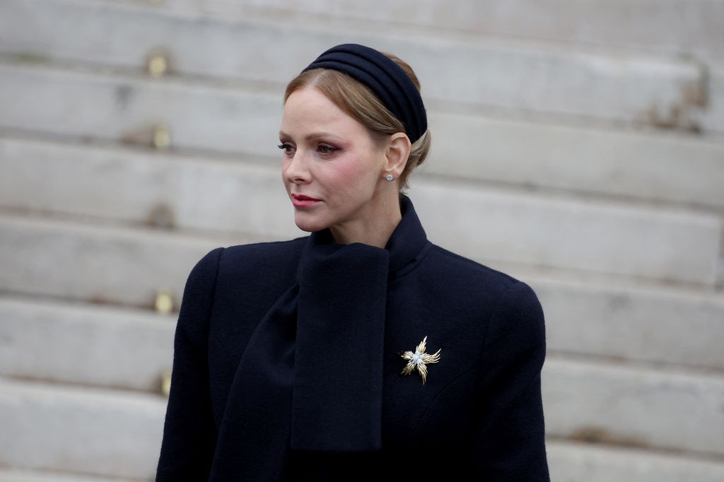 princess charlene waist up in navy headband and coat