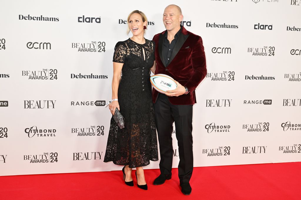 Mike holding rugby ball with zara on red carpet