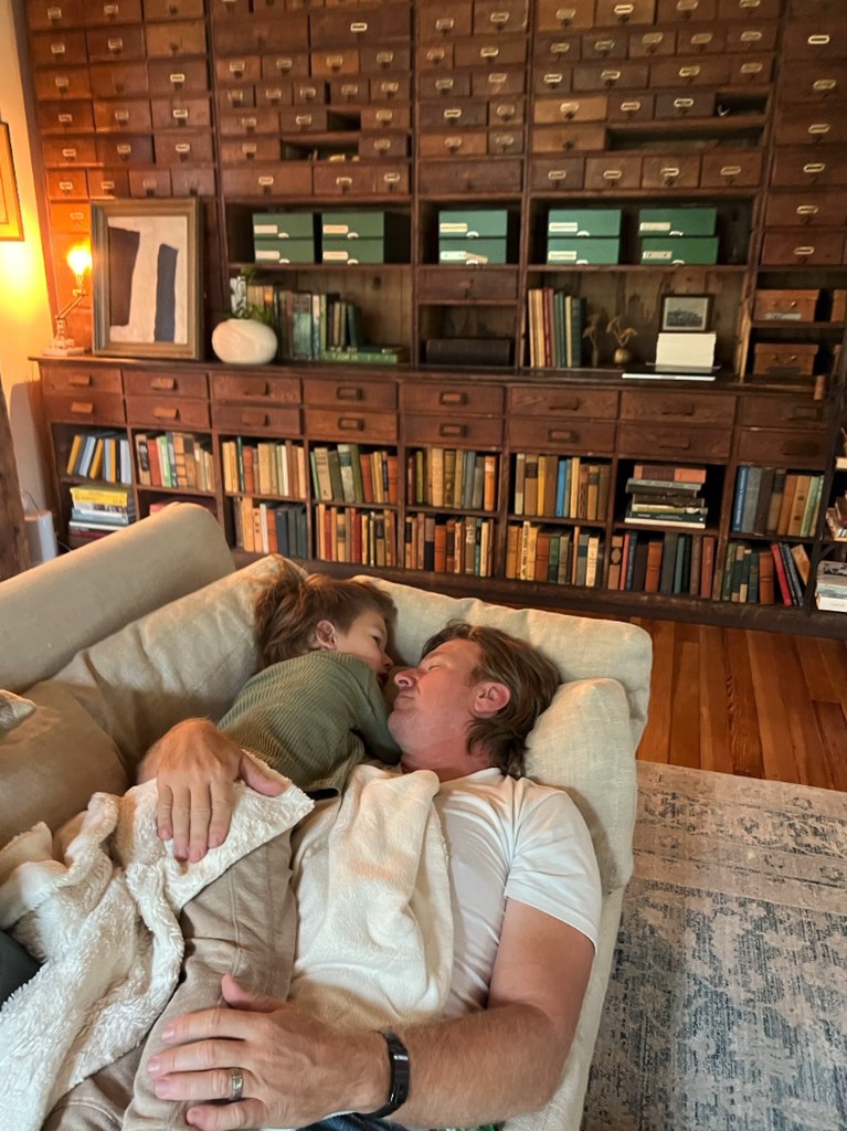 Photo shared by Joanna Gaines on Instagram in honor of Father's Day 2024 of her husband Chip Gaines cuddling with their son Crew on the couch