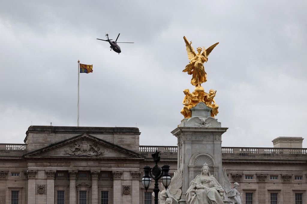 A helicopter is pictured taking off from the grounds of Buckingham Palace 