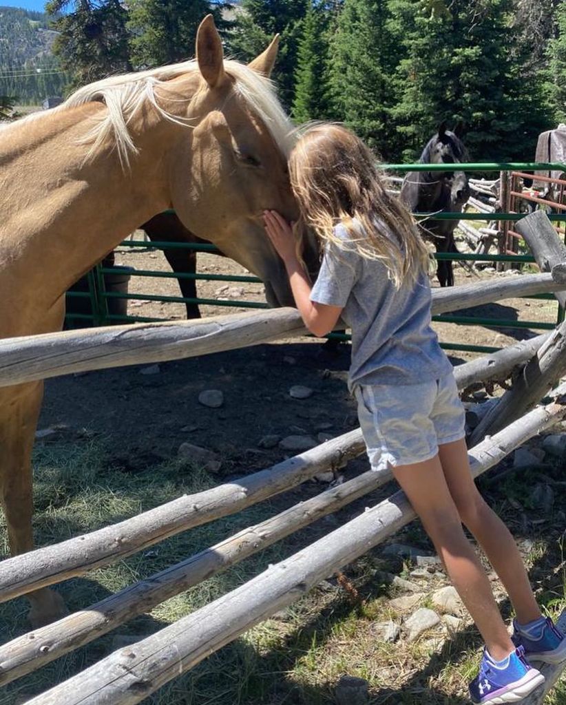 Vivian Brady gives a horse a kiss on the nose