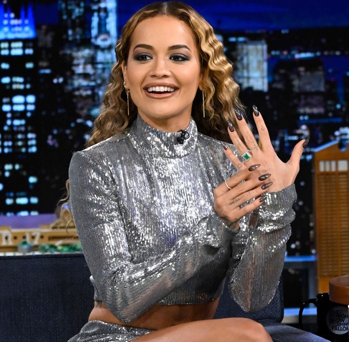 Rita Ora in a sparkly co ord showing off her emerald engagement ring