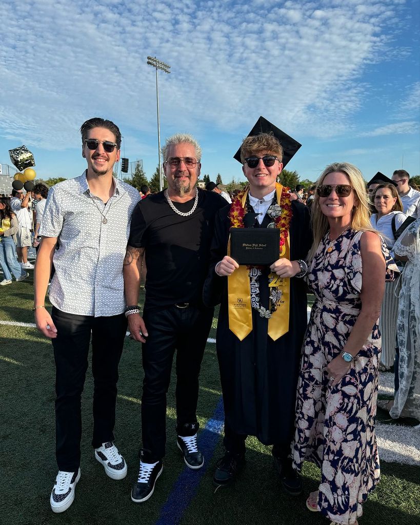 Guy Fieri poses with son Hunter (left), son Ryder (second right) and wife Lori