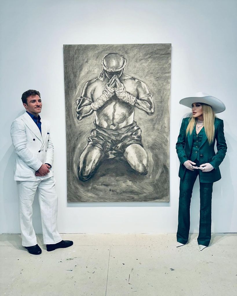 Madonna poses alongside Rocco and his artwork