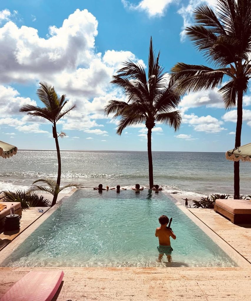 Five kids in the pool, palm trees seaside