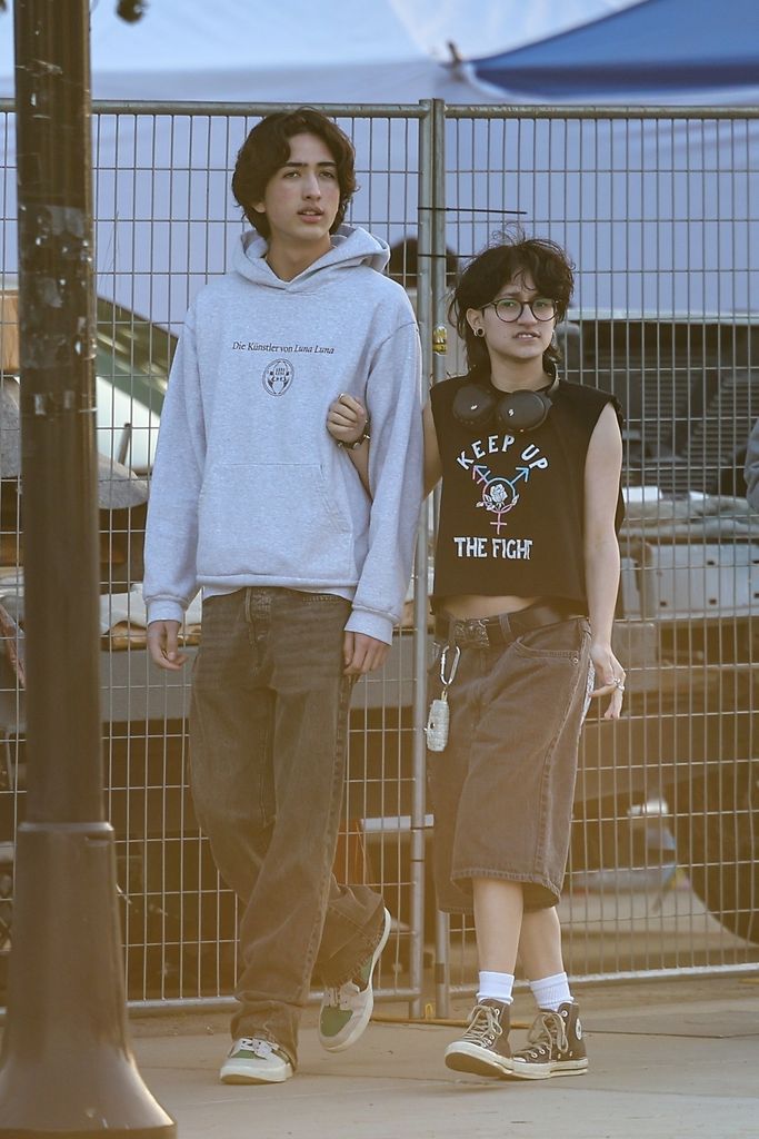 Emme Muniz links arms with friend in LA