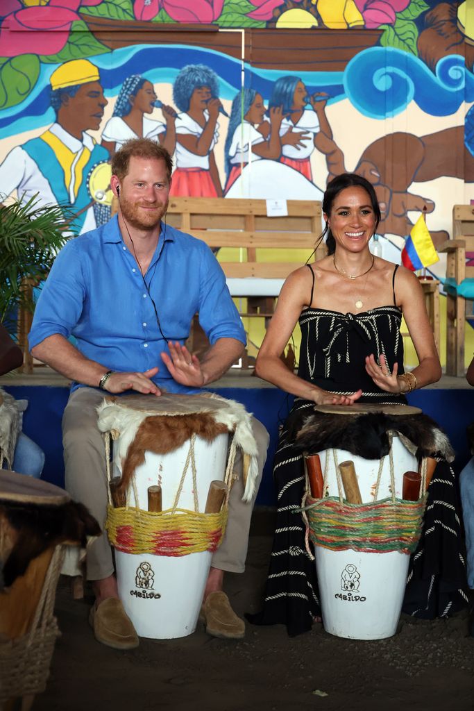 Prince Harry and Meghan Markle play with drums